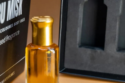 Perfume bottle with gold cap and amber liquid next to a black box with 'MISK' branding.